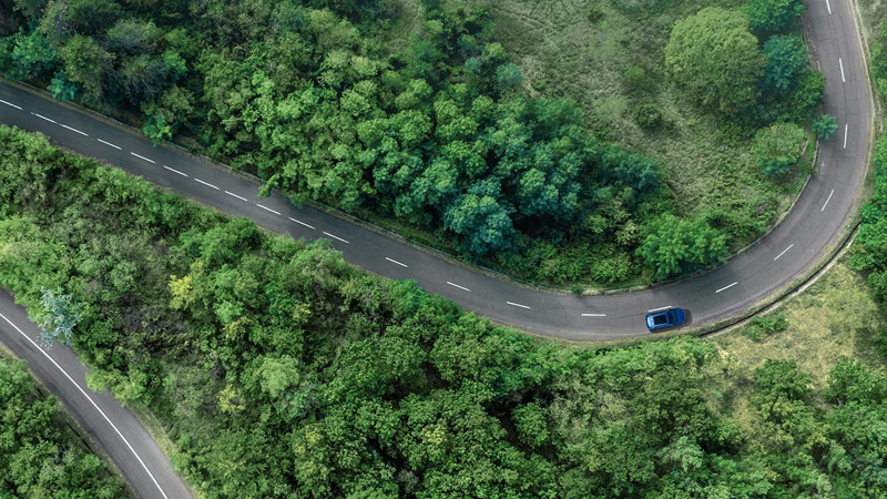 Aerial view of a road through green landscape representing sustainable repairs